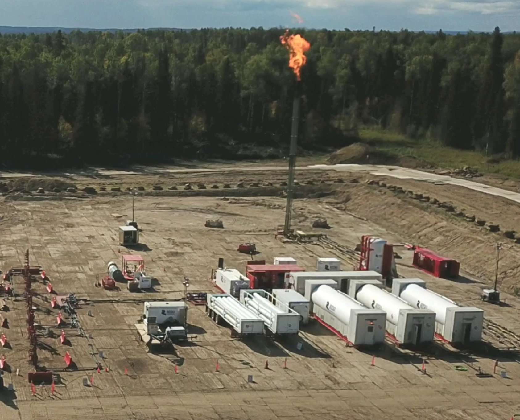 Field technicians conducting oil and gas production testing using portable separators and test equipment at a wellsite.